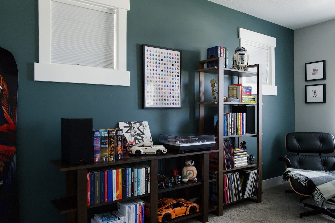 a photograph of the back wall of my office, showing my bookshelves, decor, and a lounge chair