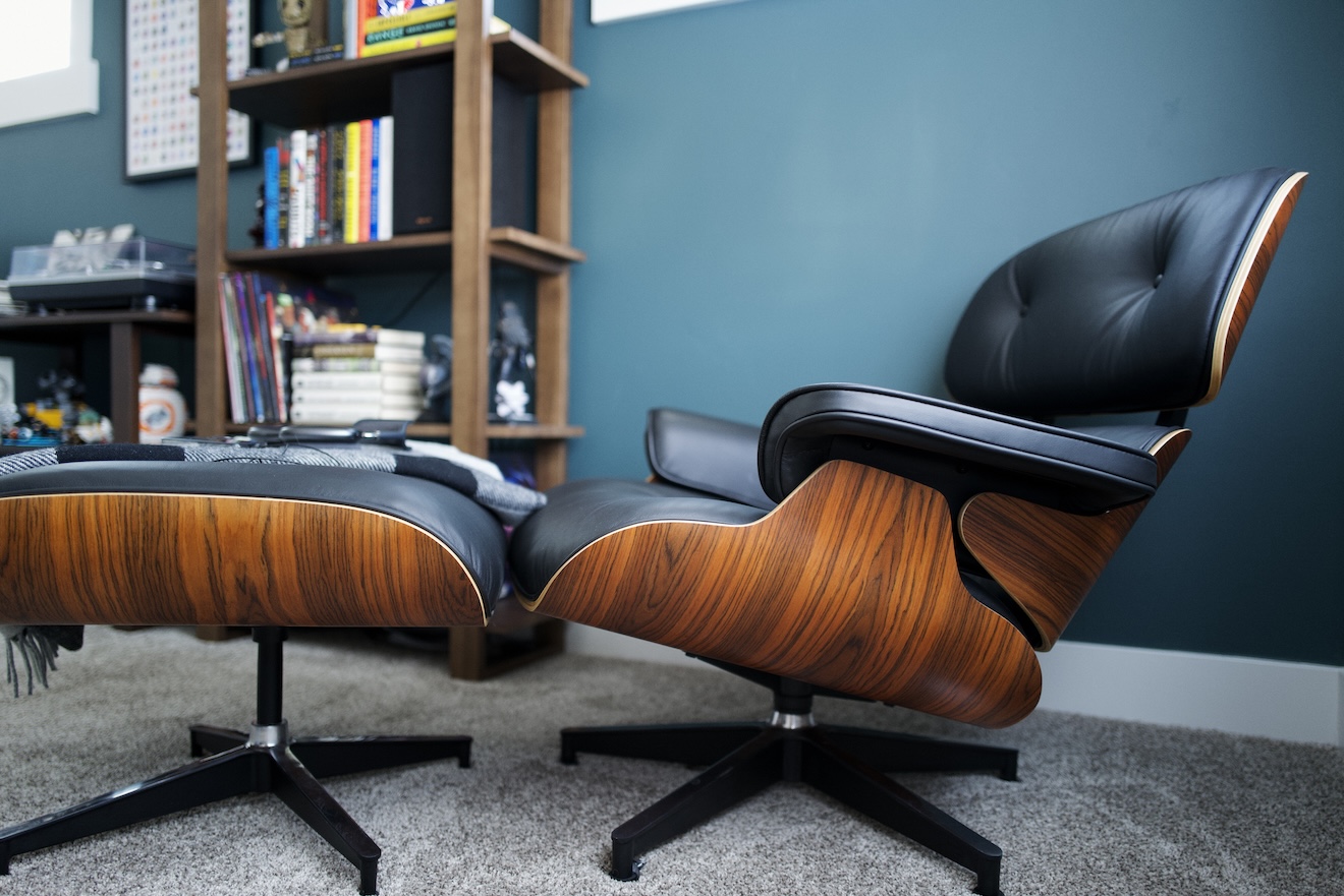 a photograph of the back wall of my office, showing my bookshelves, decor, and a lounge chair