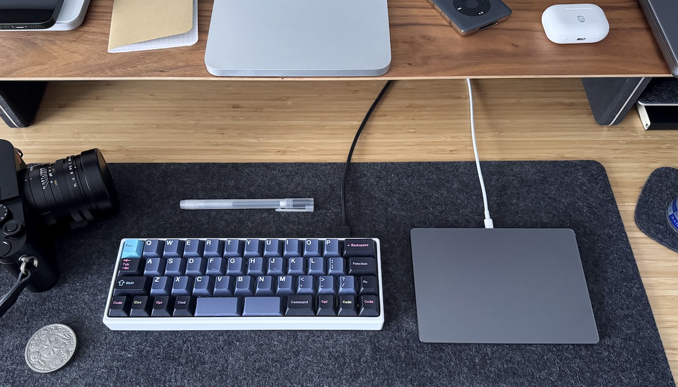 A photograph of my keyboard and trackpad on my desk